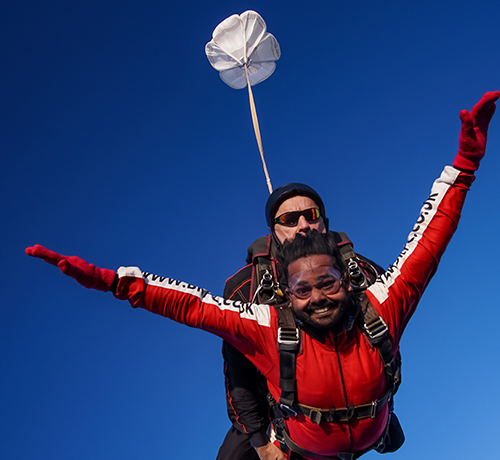 Tandem skydive in Cumbria with instructor and jumper against a blue sky