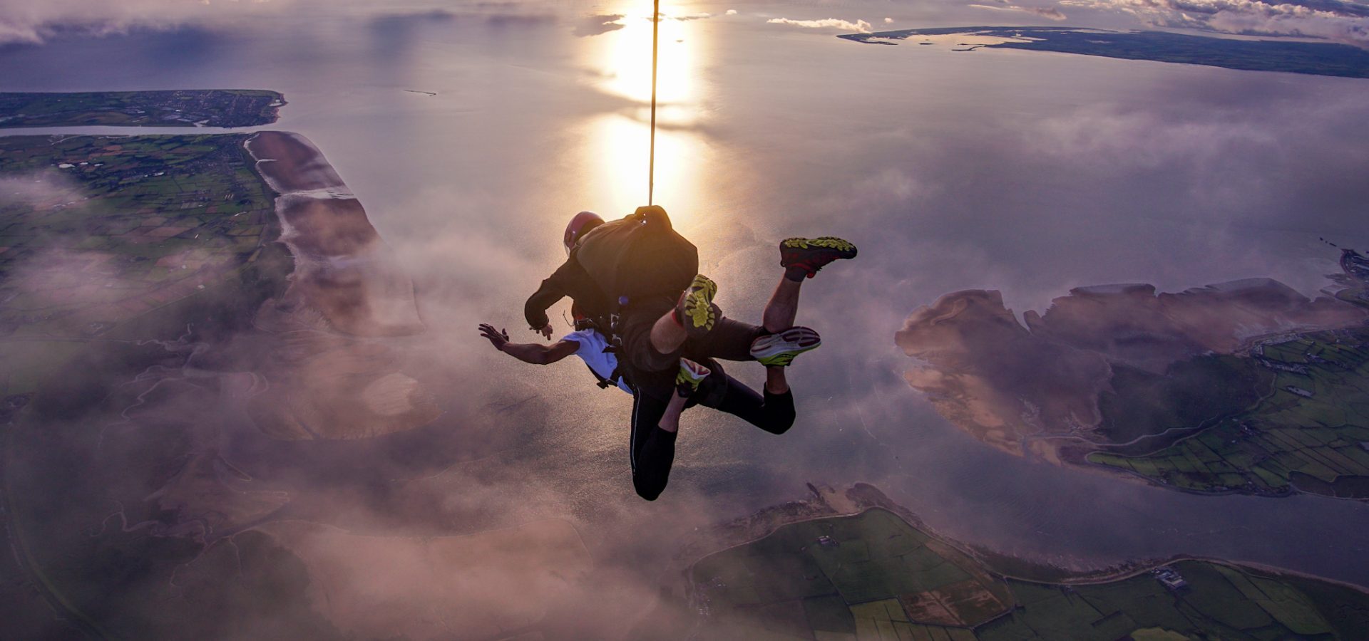 Tandem skydiving above the Cumbrian coast with sea views below